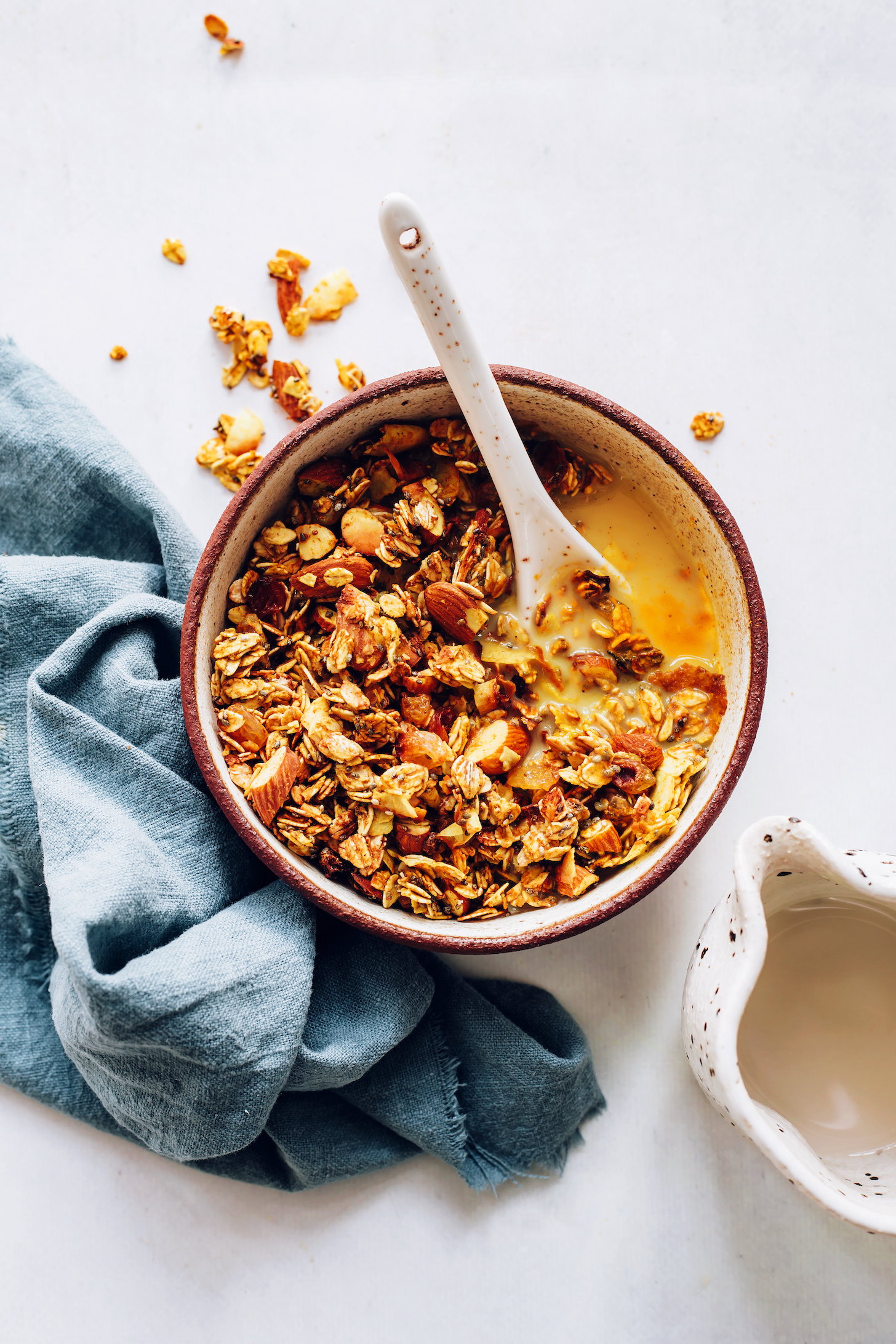 Spoon in a bowl of golden milk granola