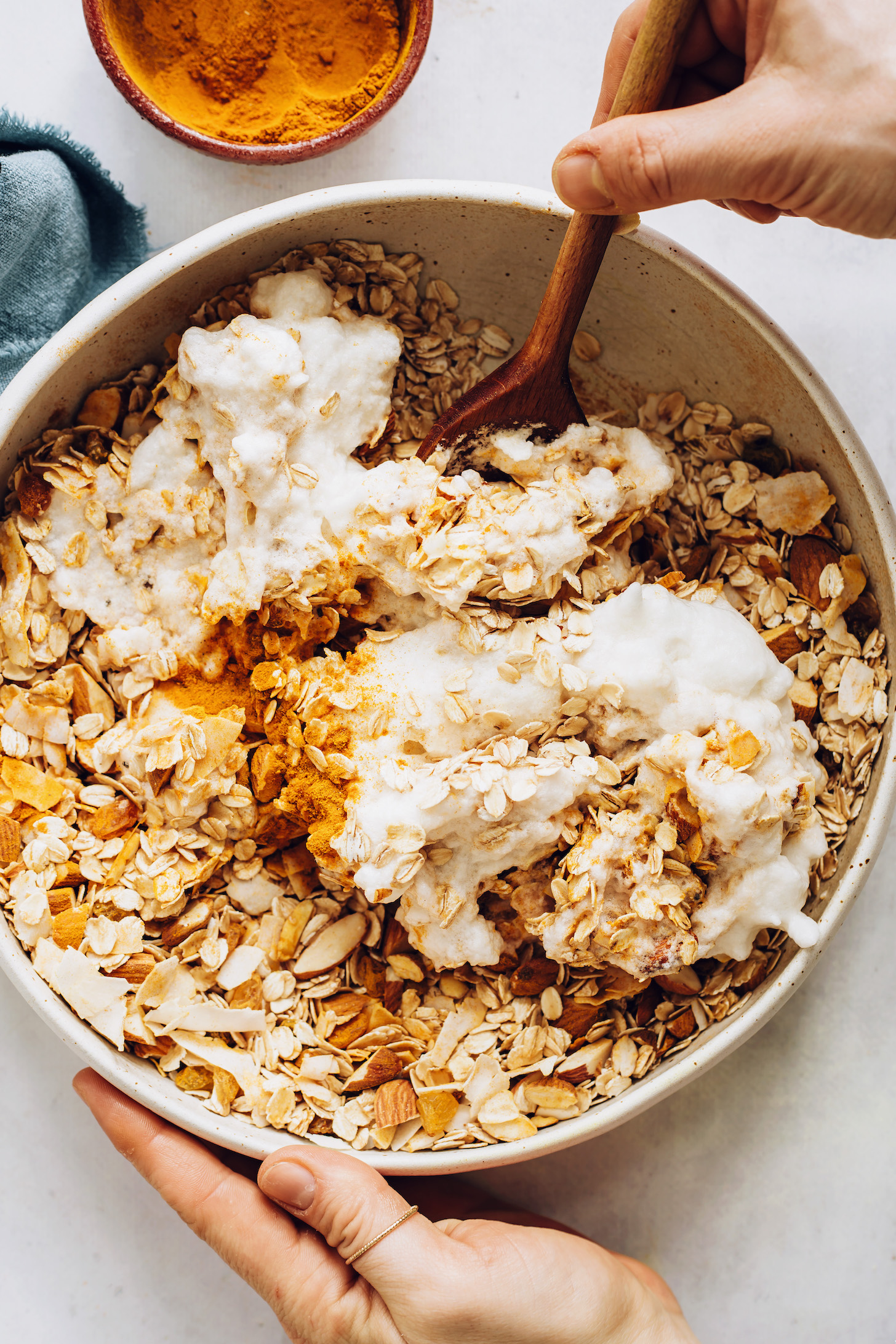 Stirring aquafaba with golden milk granola ingredients