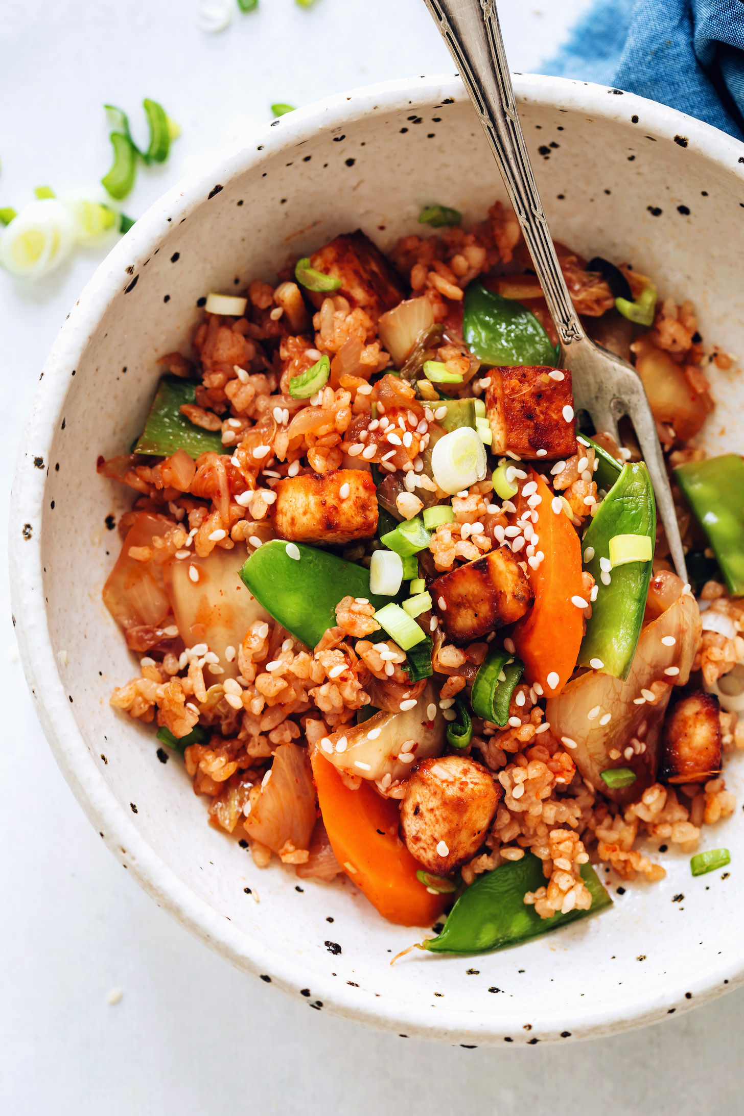 Bowl of kimchi fried rice with tofu and vegetables