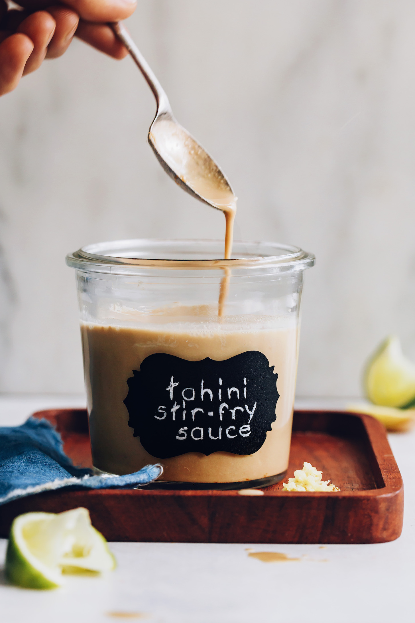 Jar and spoonful of our easy stir fry sauce made with tahini