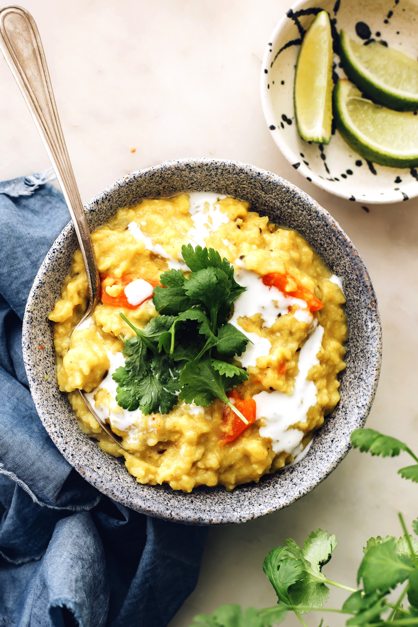 Lime wedges next to a bowl of Instant Pot kitchari