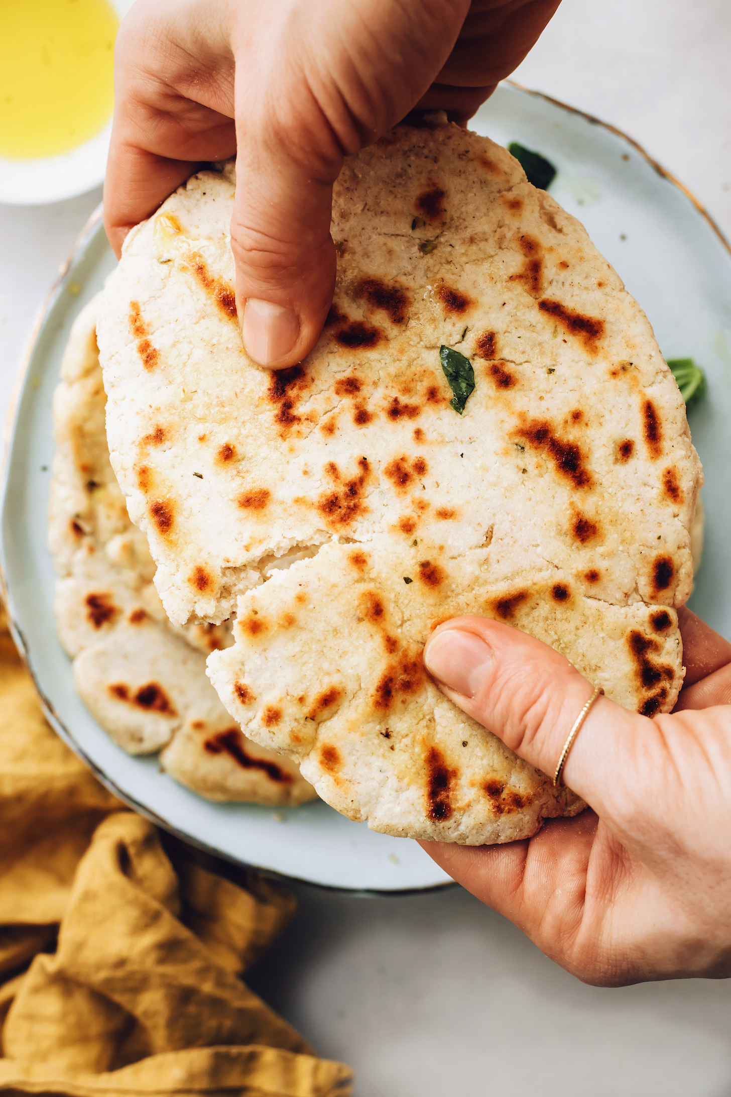 Breaking apart a piece of gluten-free flatbread