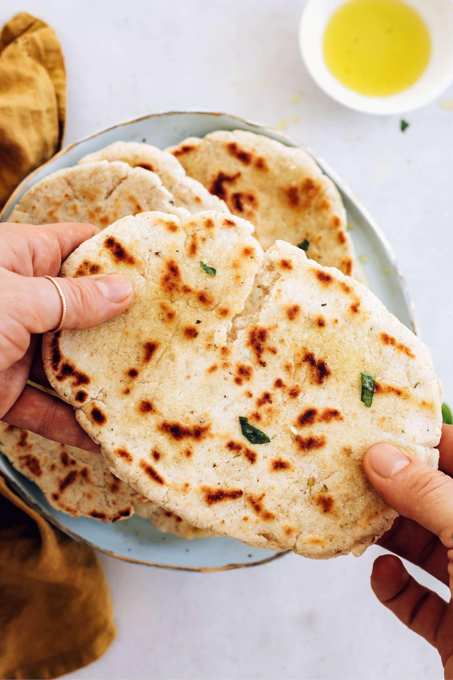 Holding a piece of gluten-free flatbread