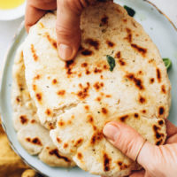 Breaking apart a piece of gluten-free flatbread