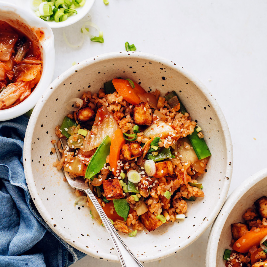 Bowl of Kimchi Fried Rice made with snap peas and carrots
