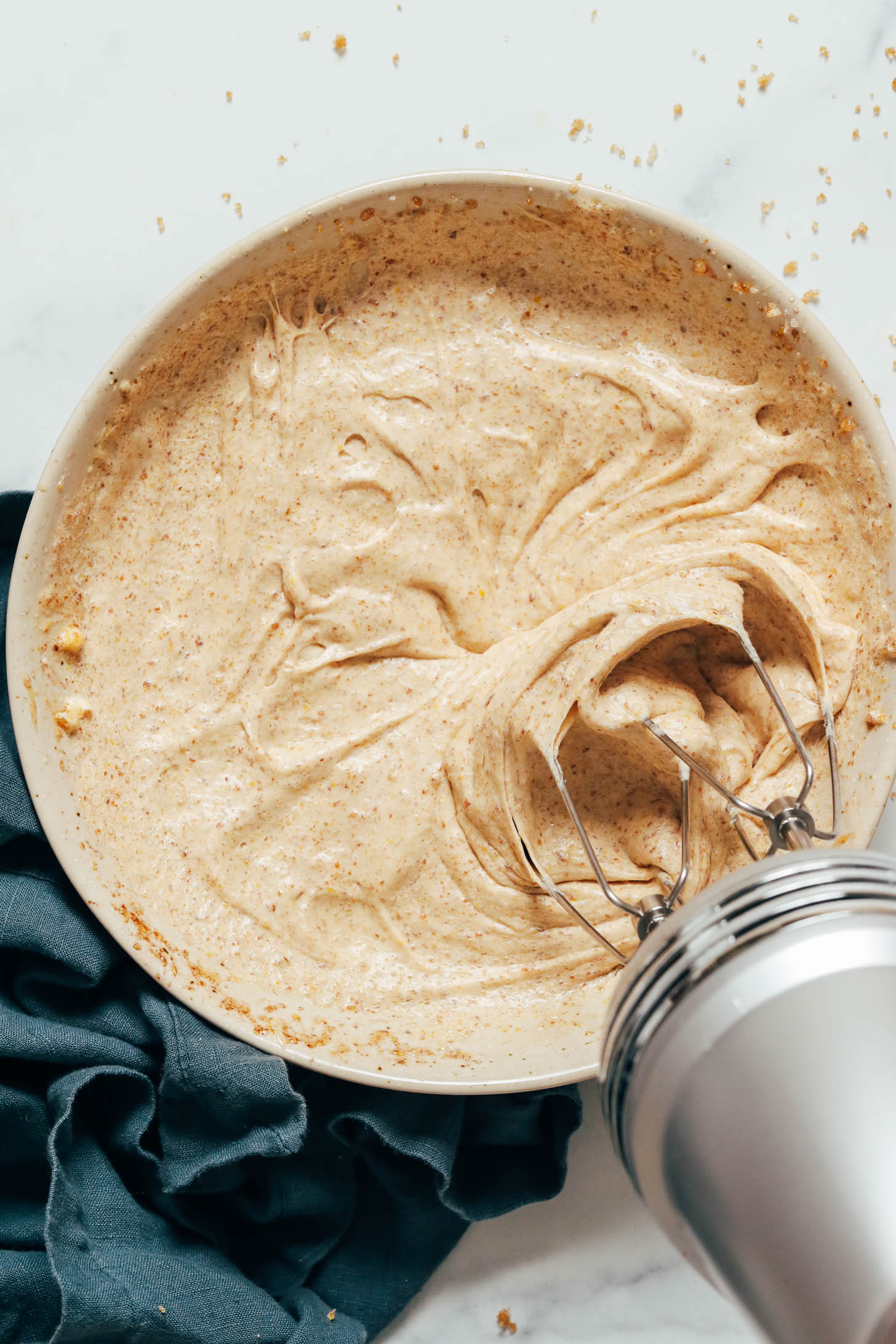 Whipping vegan butter with sugar, flaxseed meal, and vanilla