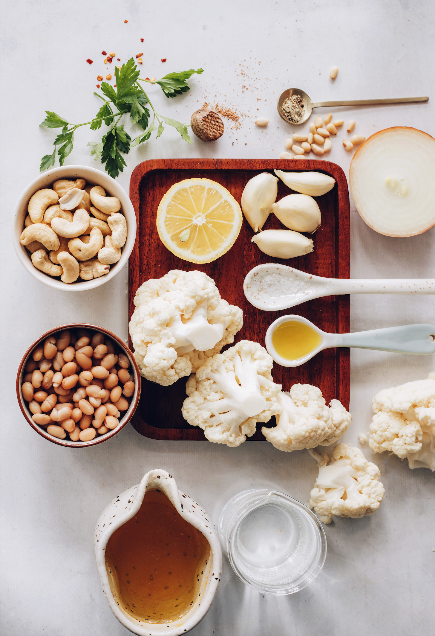 Onion, garlic, cauliflower avocado oil, salt, pepper, water, white beans, nutmeg, cashews, lemon juice, parsley, pine nuts, and pepper flakes