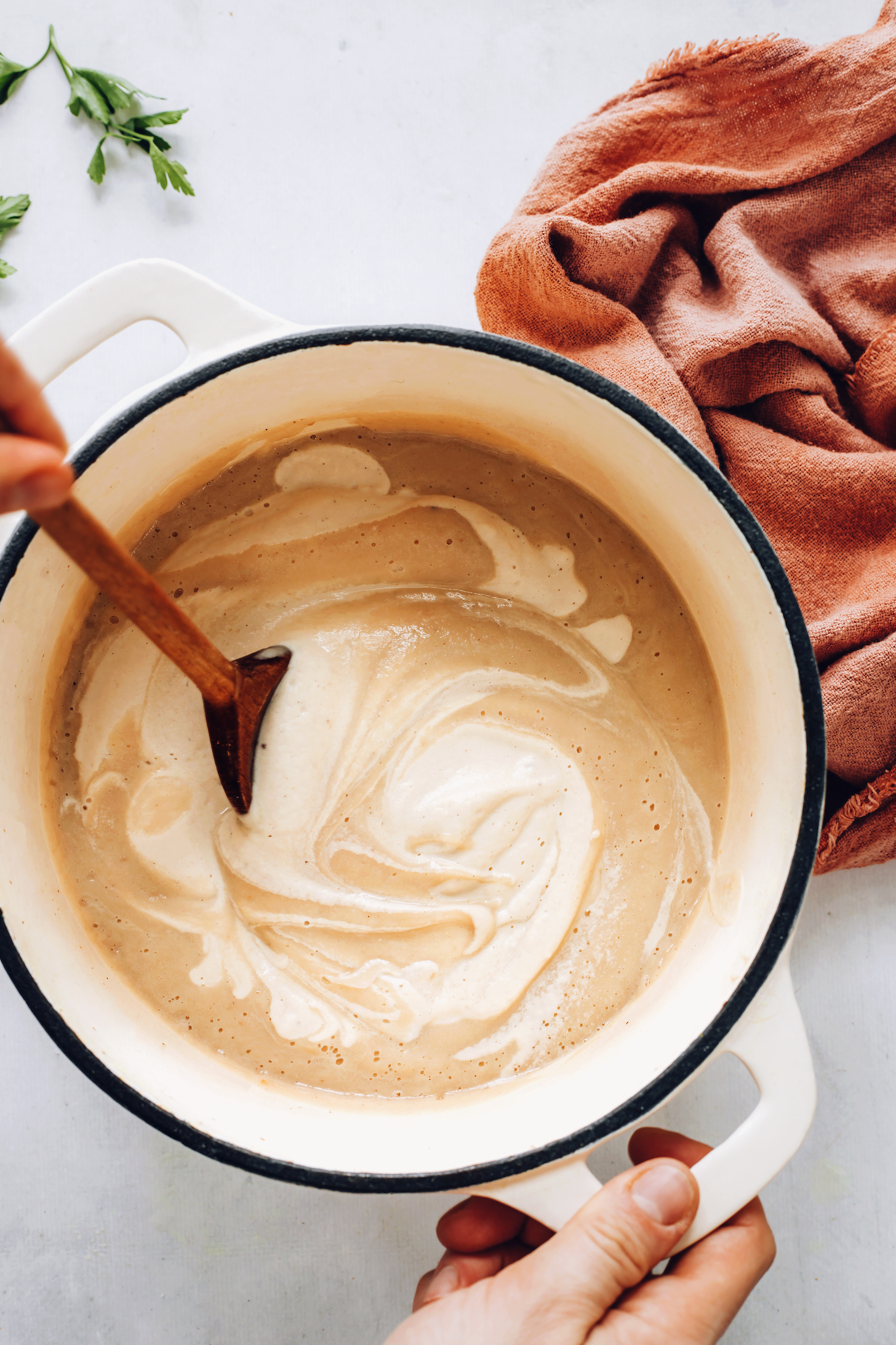 Swirl of cashew milk in vegan roasted cauliflower soup