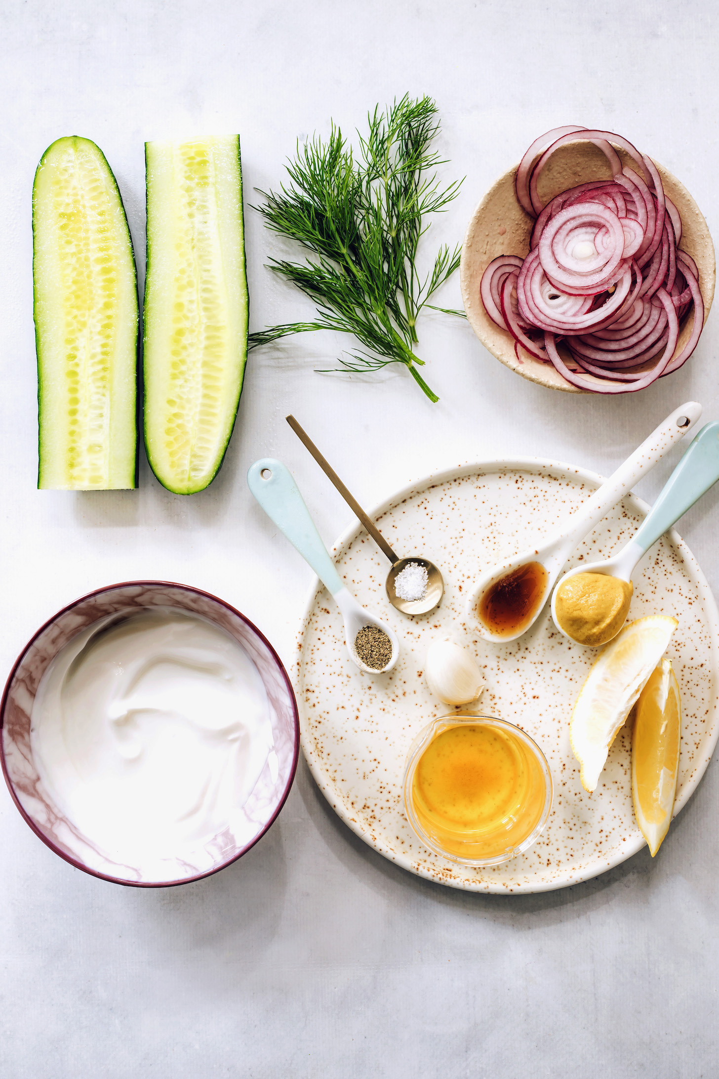 Cucumber, dill, red onion, mustard, maple syrup, salt, pepper, apple cider vinegar, lemon, garlic, and vegan yogurt