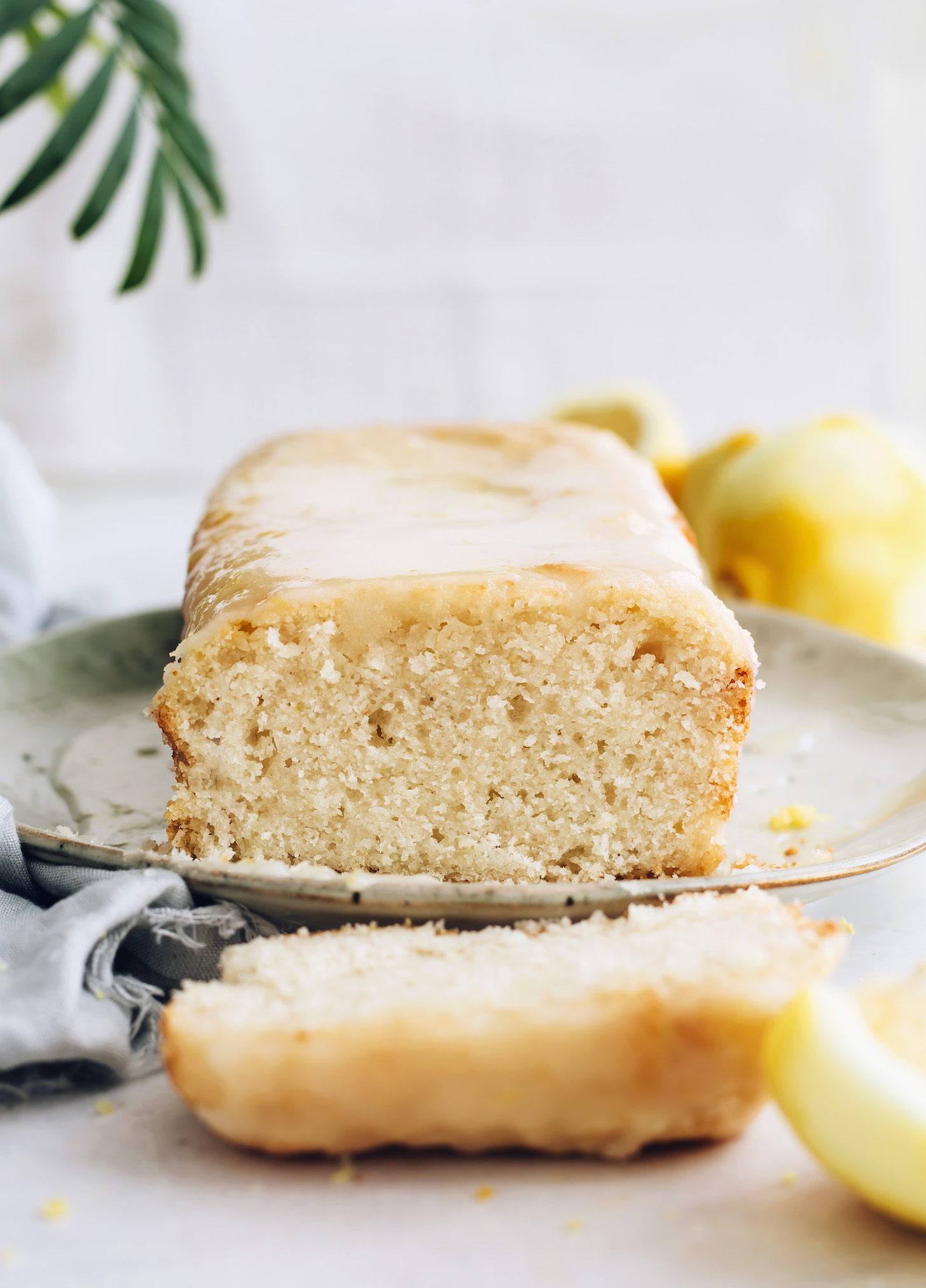 Partially sliced loaf of vegan lemon cake