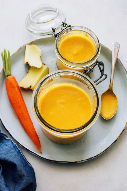 Ginger and carrot next to jars of our carrot ginger dressing recipe