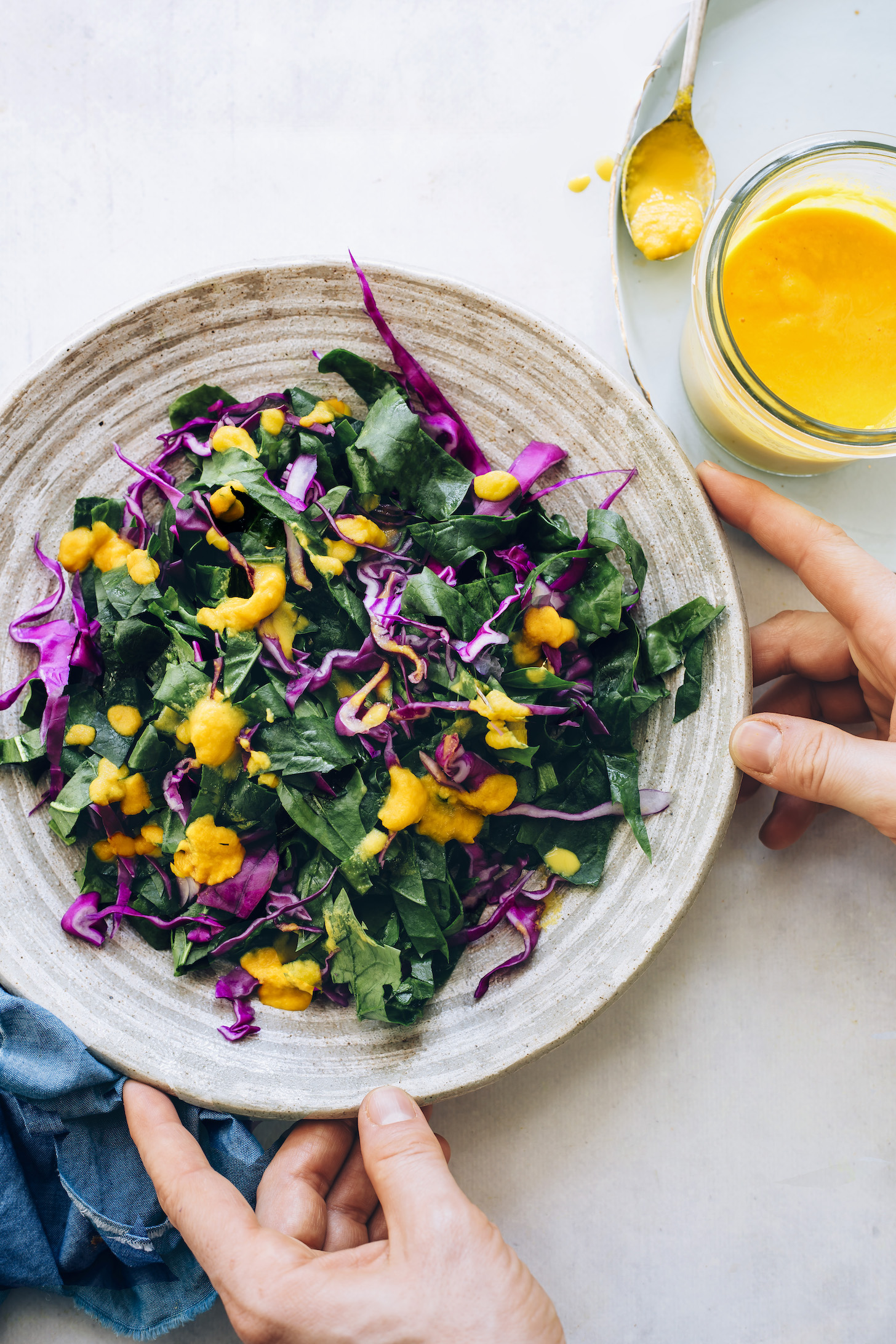 Kale and cabbage topped with carrot ginger dressing