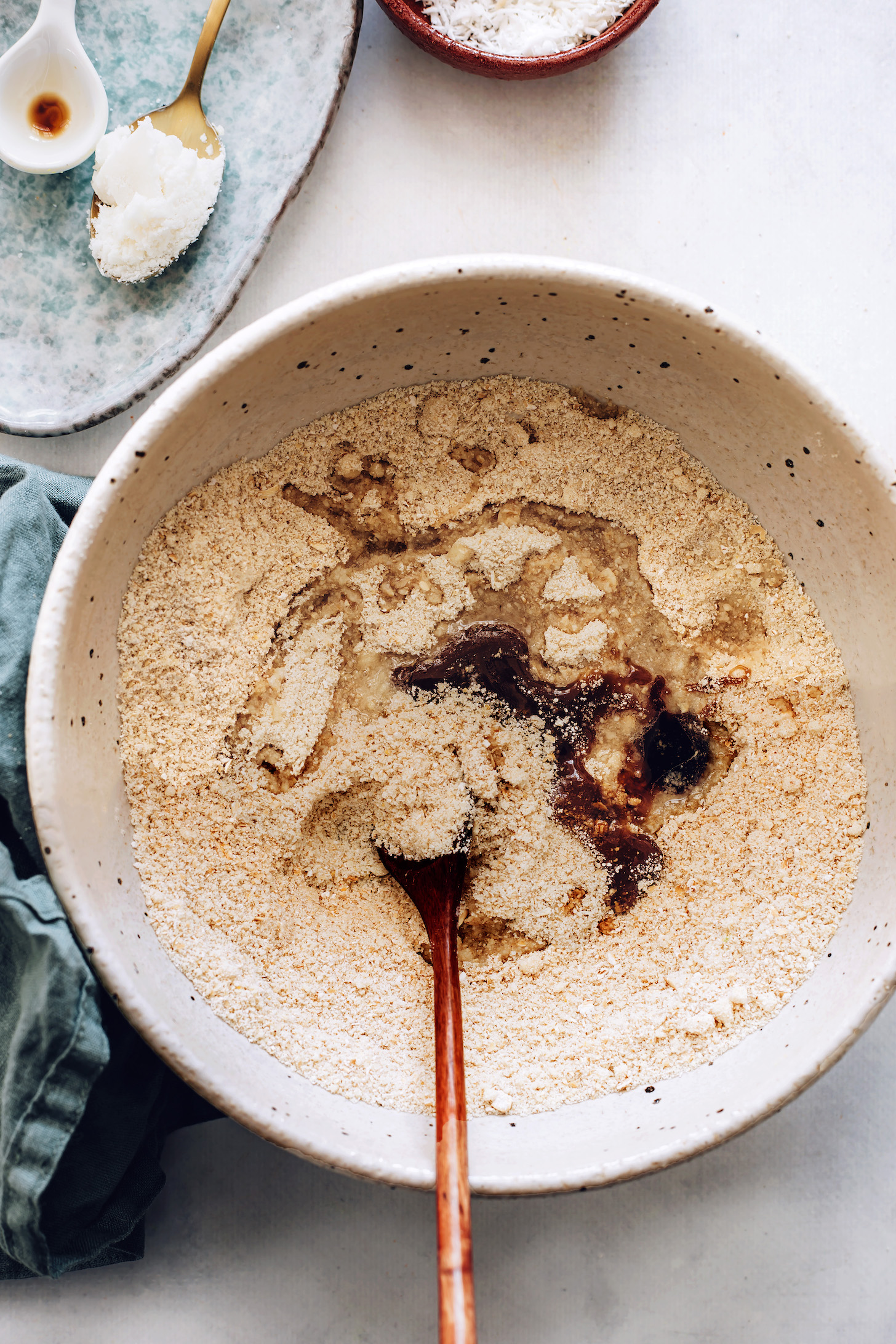 Mixing wet and dry ingredients for cookie dough bites in a mixing bowl