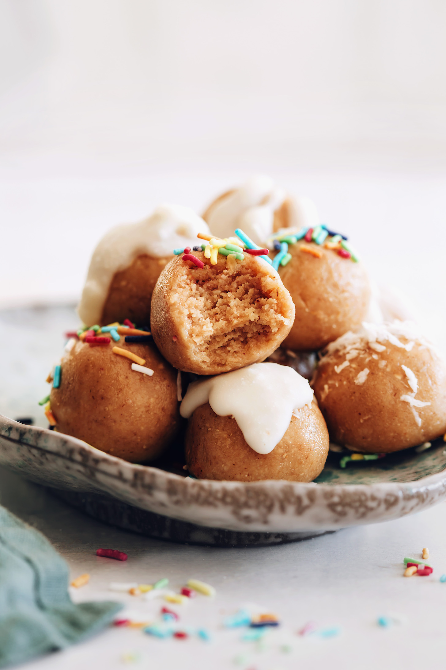 Plate of no-bake sugar cookie bites with some topped with sprinkles or glaze