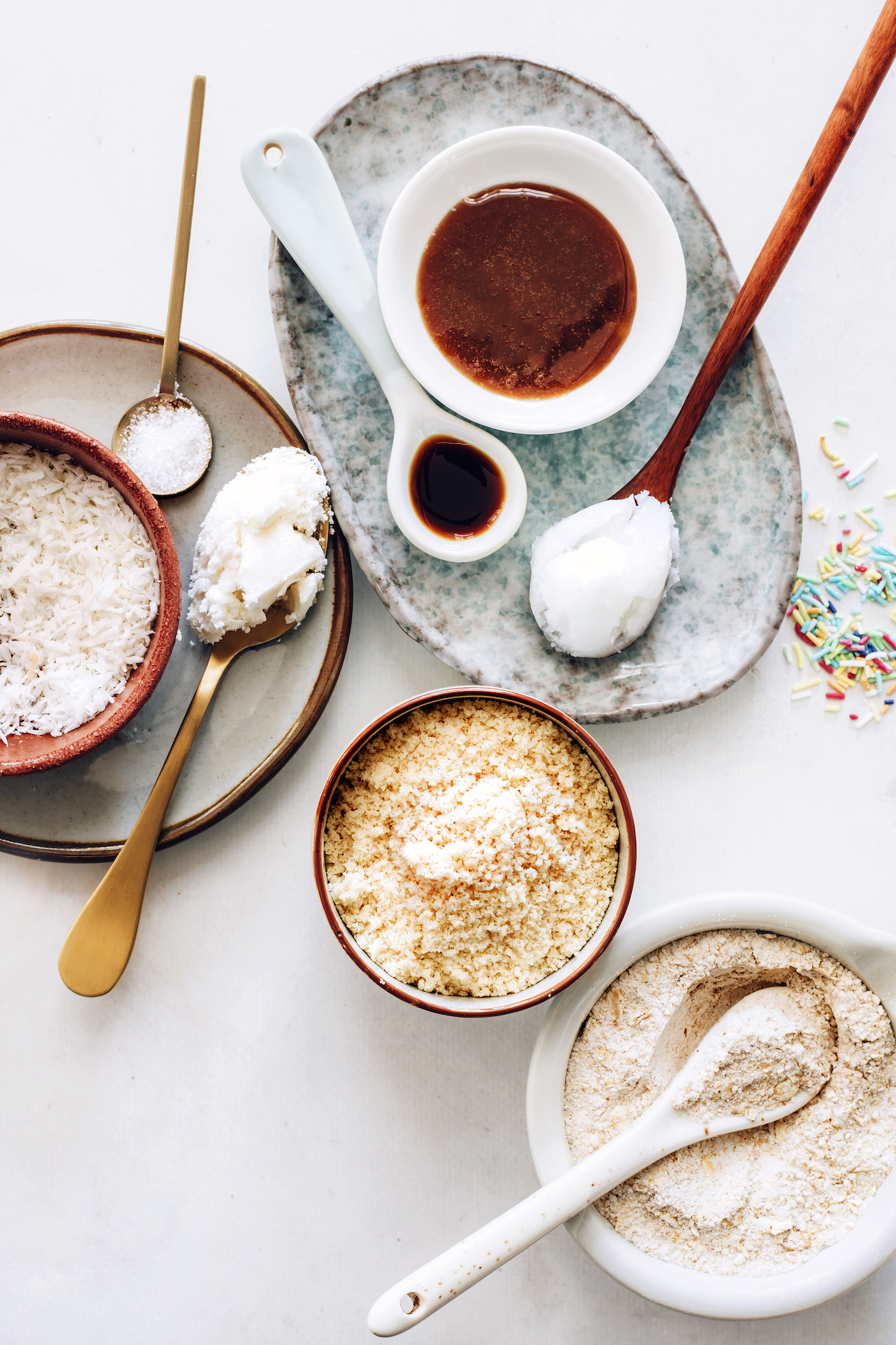 Oat flour, almond flour, sea salt, coconut oil, maple syrup, vanilla, coconut butter, coconut oil, shredded coconut, and sprinkles
