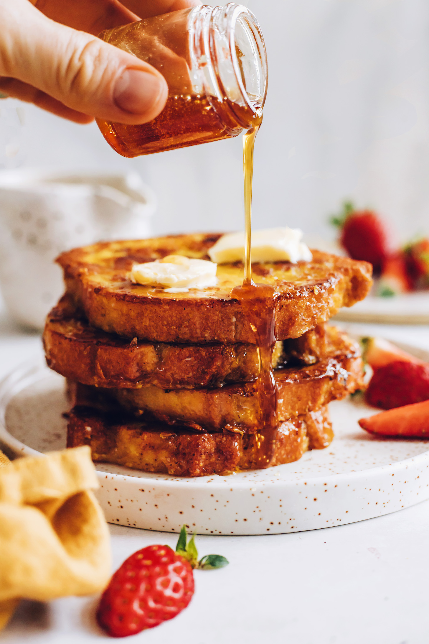 Maple syrup being drizzled over vegan French toast