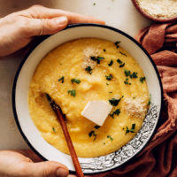 Holding the sides of a bowl of vegan polenta