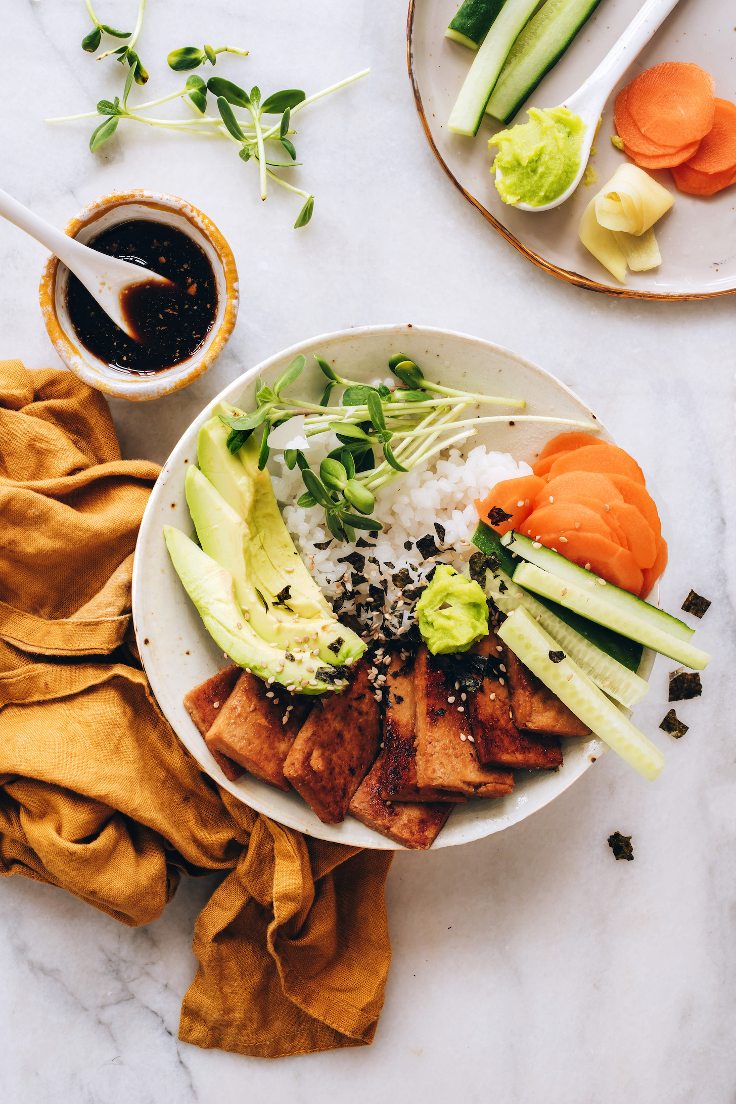 Ginger tamari sauce next to a vegan sushi bowl
