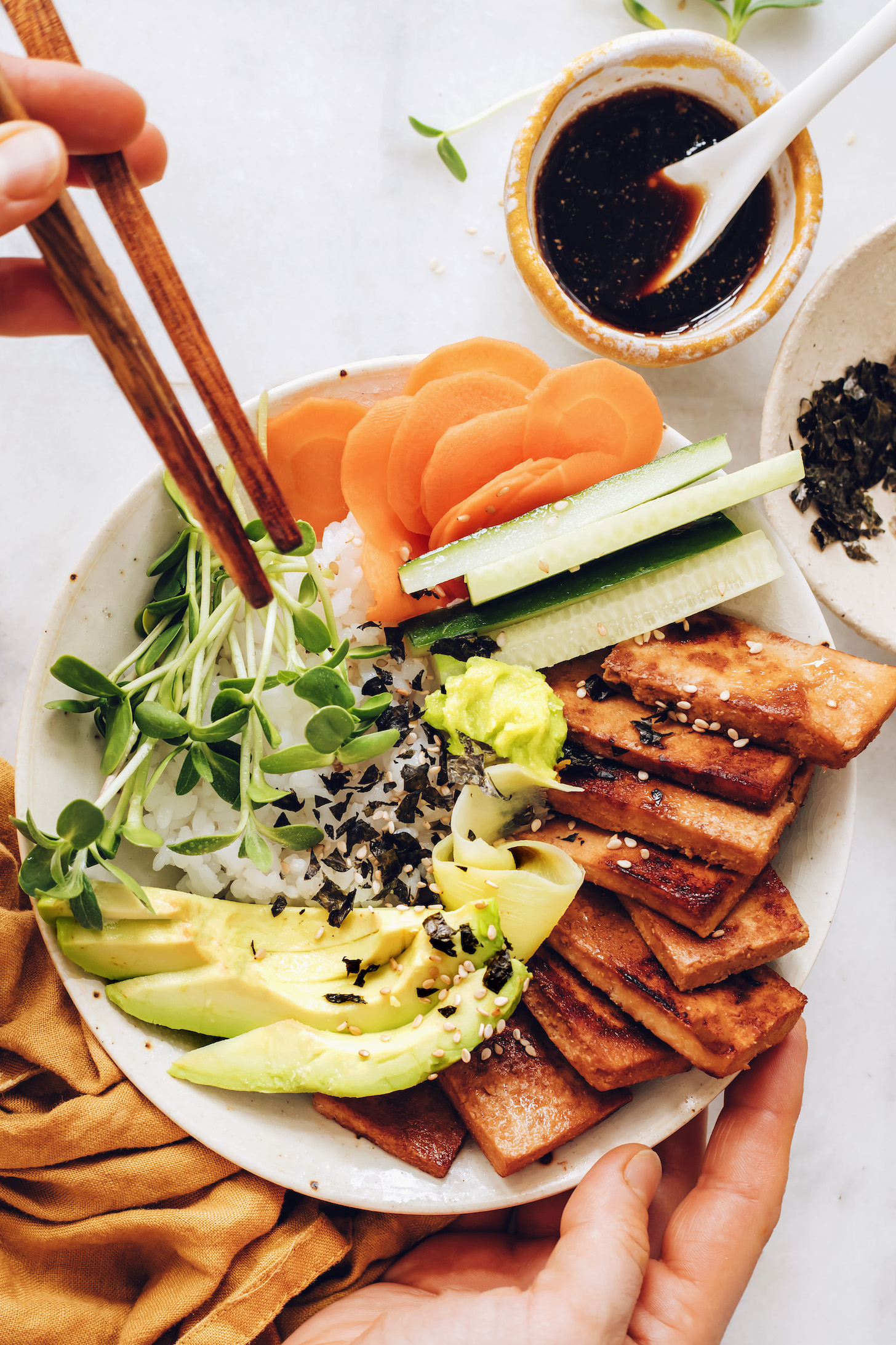 Chopsticks over a vegan sushi bowl