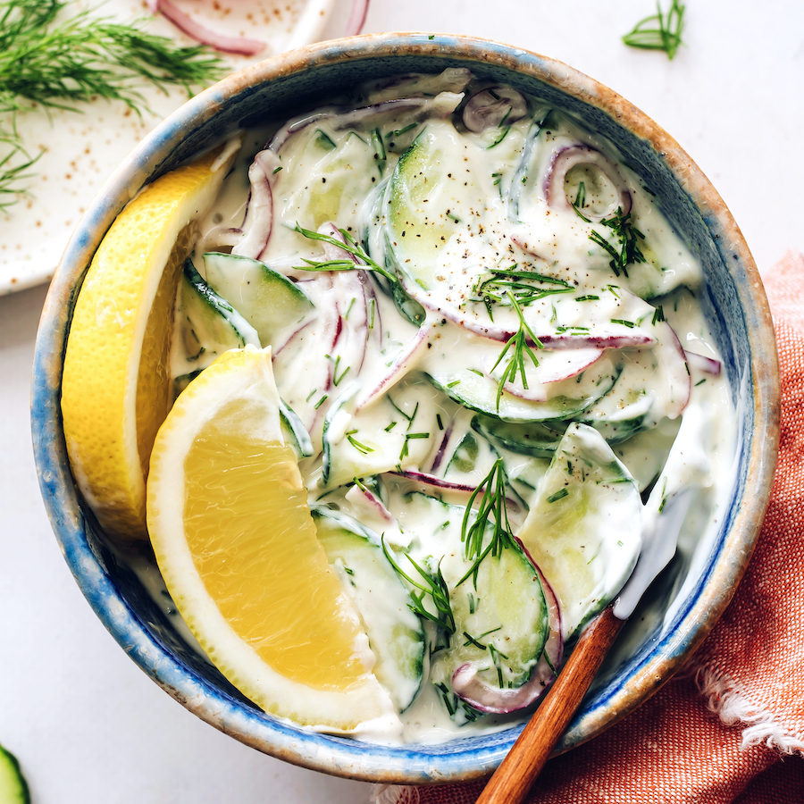 Top down shot of a bowl of creamy cucumber salad
