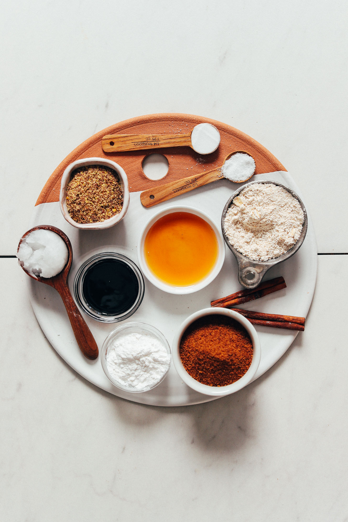Tray with coconut sugar, baking soda, sea salt, cinnamon, maple syrup, molasses, coconut oil, oat flour, arrowroot starch, and ground flax
