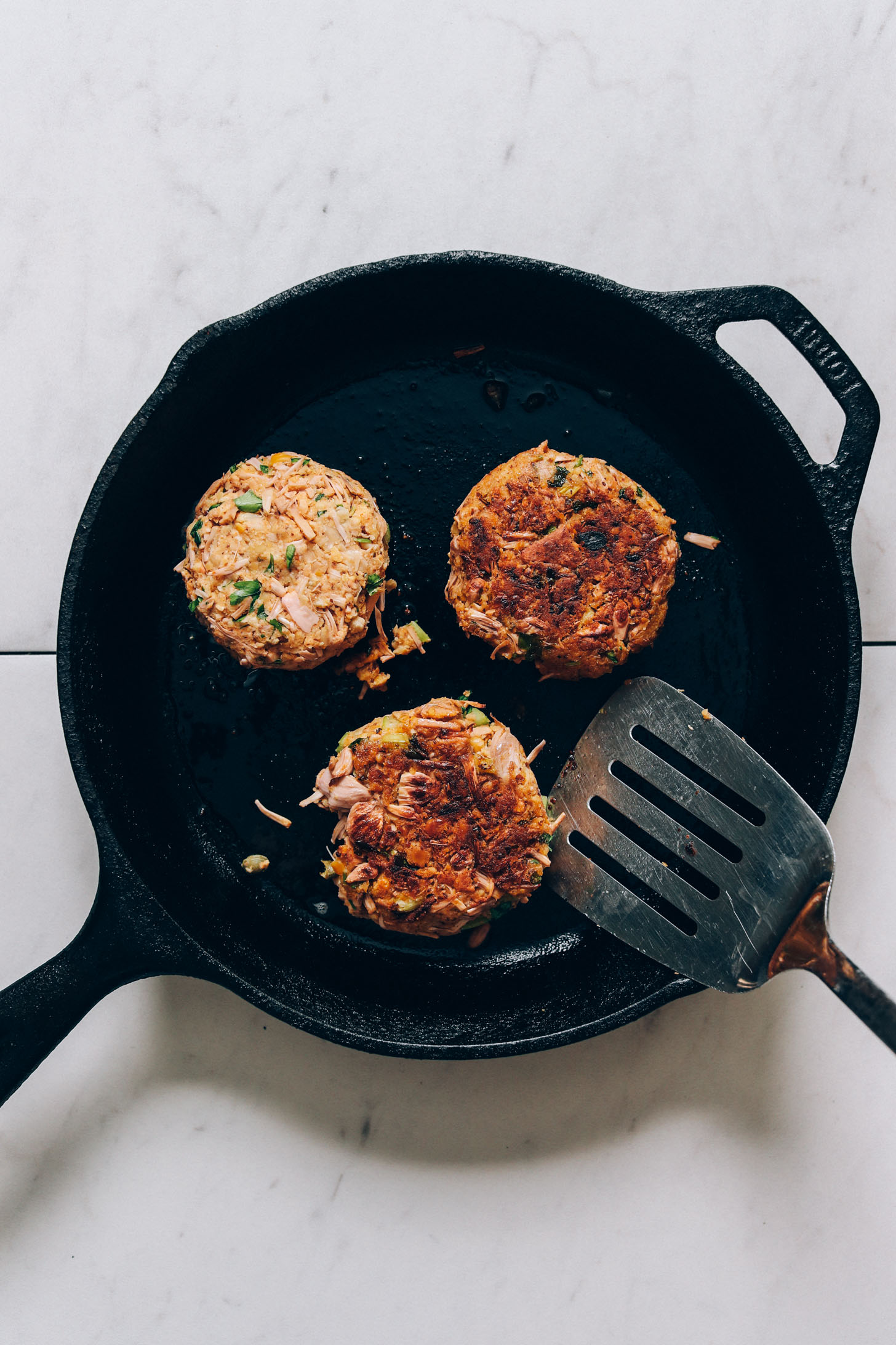 Cooking vegan crab cakes in a cast iron skillet
