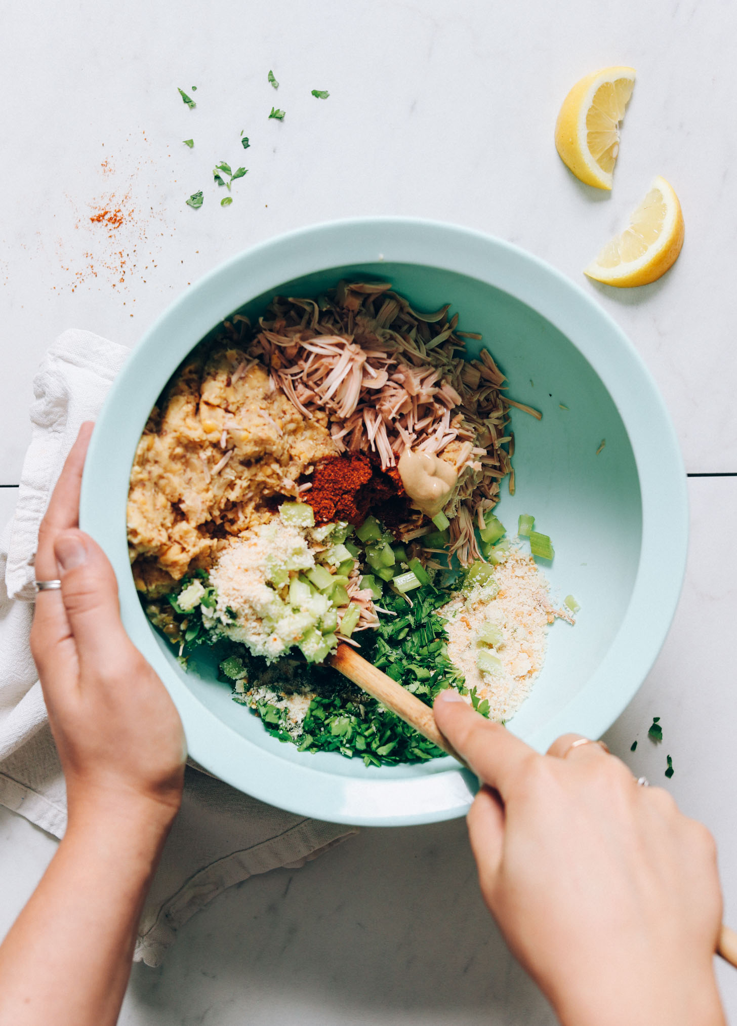 Bowl of jackfruit, mashed chickpeas, celery, parsley, Old Bay seasoning, and bread crumbs