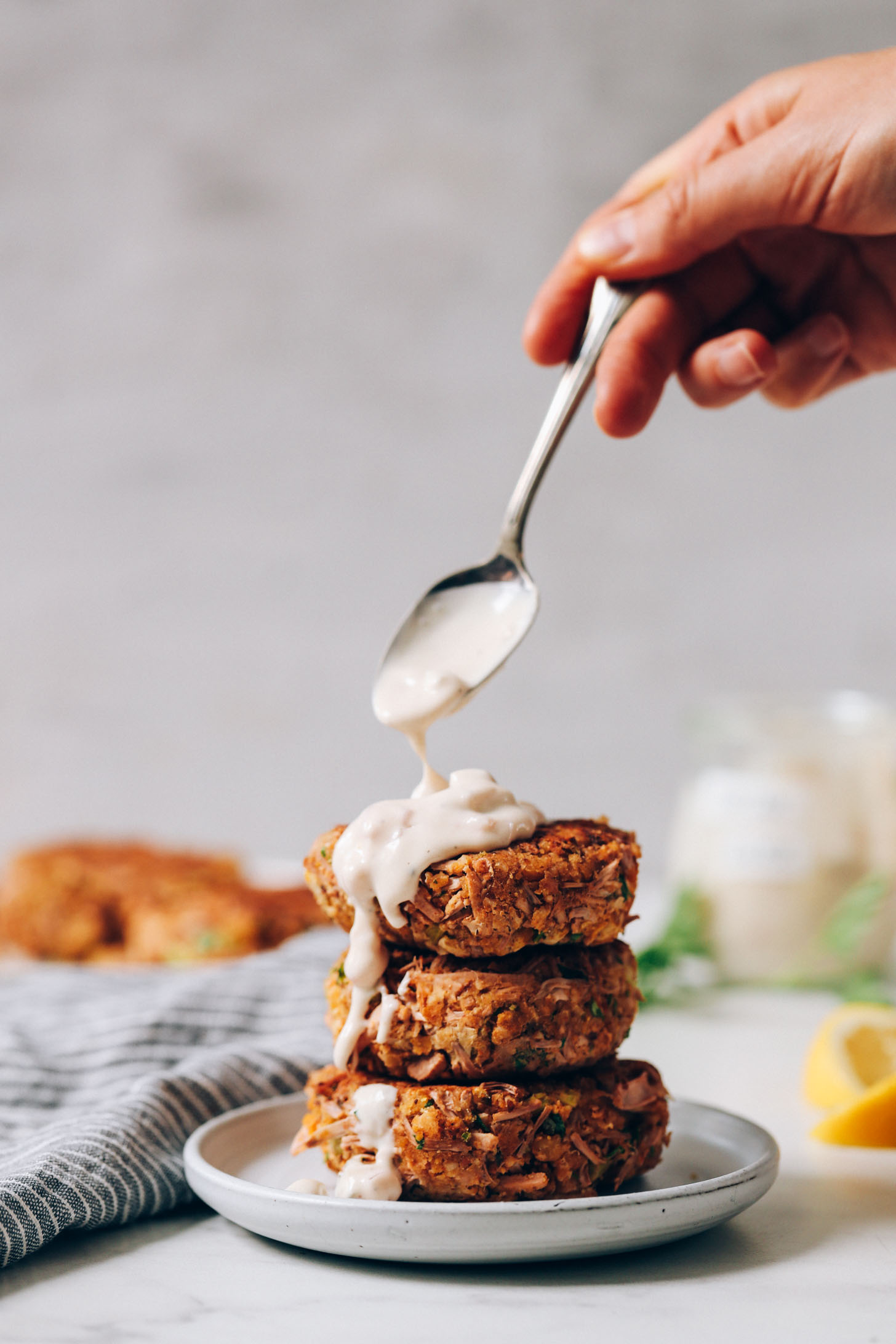 Vegan crab cakes topped with vegan tartar sauce