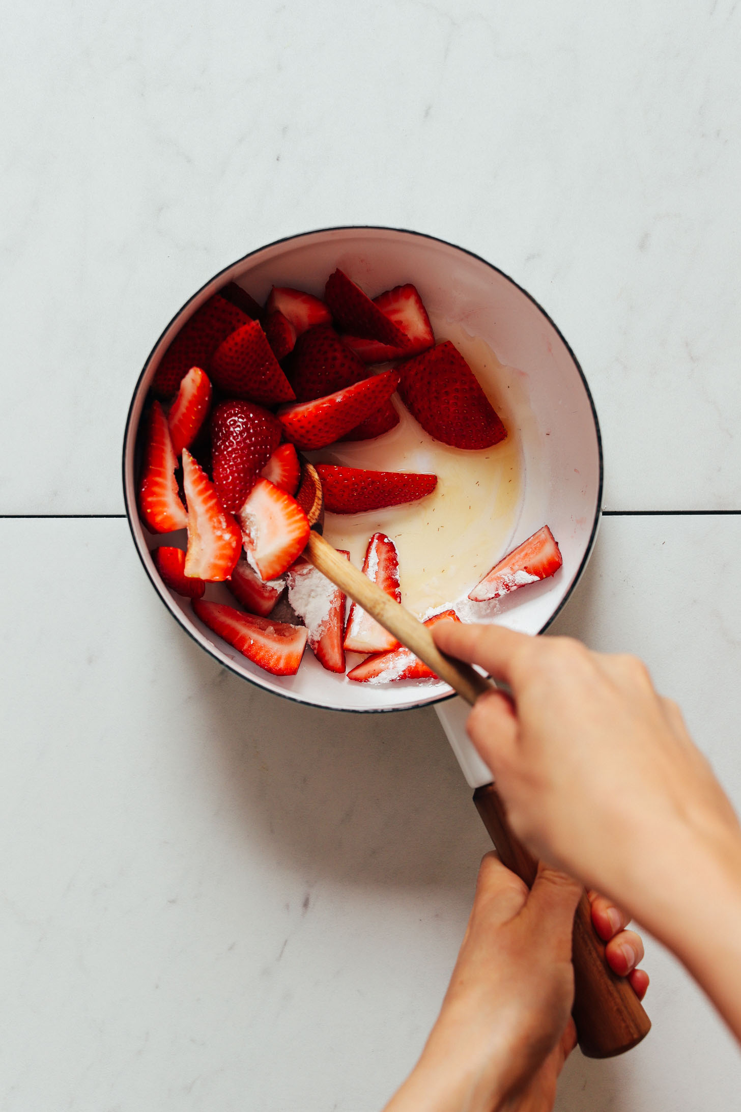 Saucepan of fresh strawberries, cornstarch, water, and maple syrup