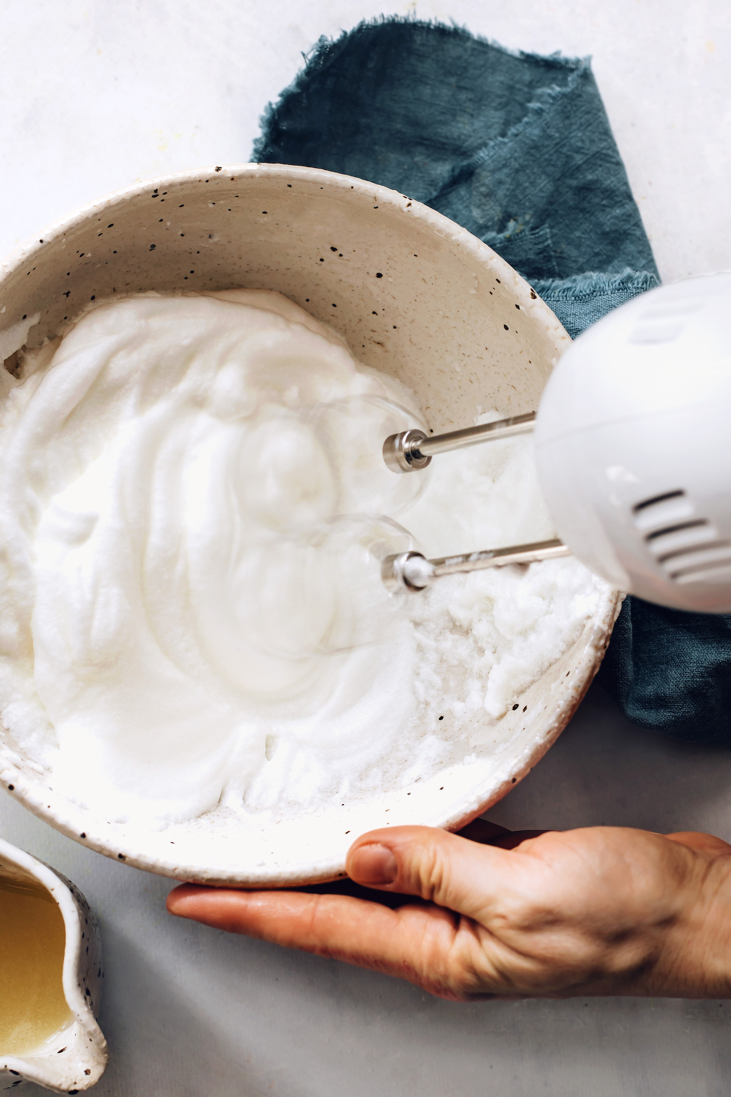 Bowl of whipped aquafaba for making oil-free granola
