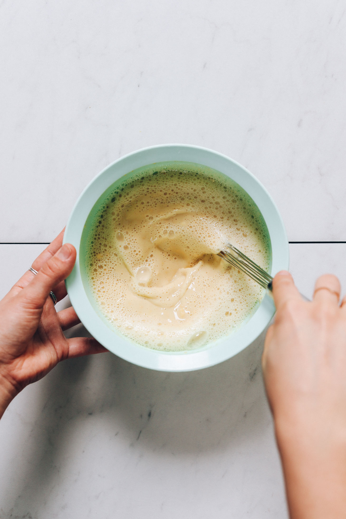 Whisking chickpea flour, water, and salt in a bowl