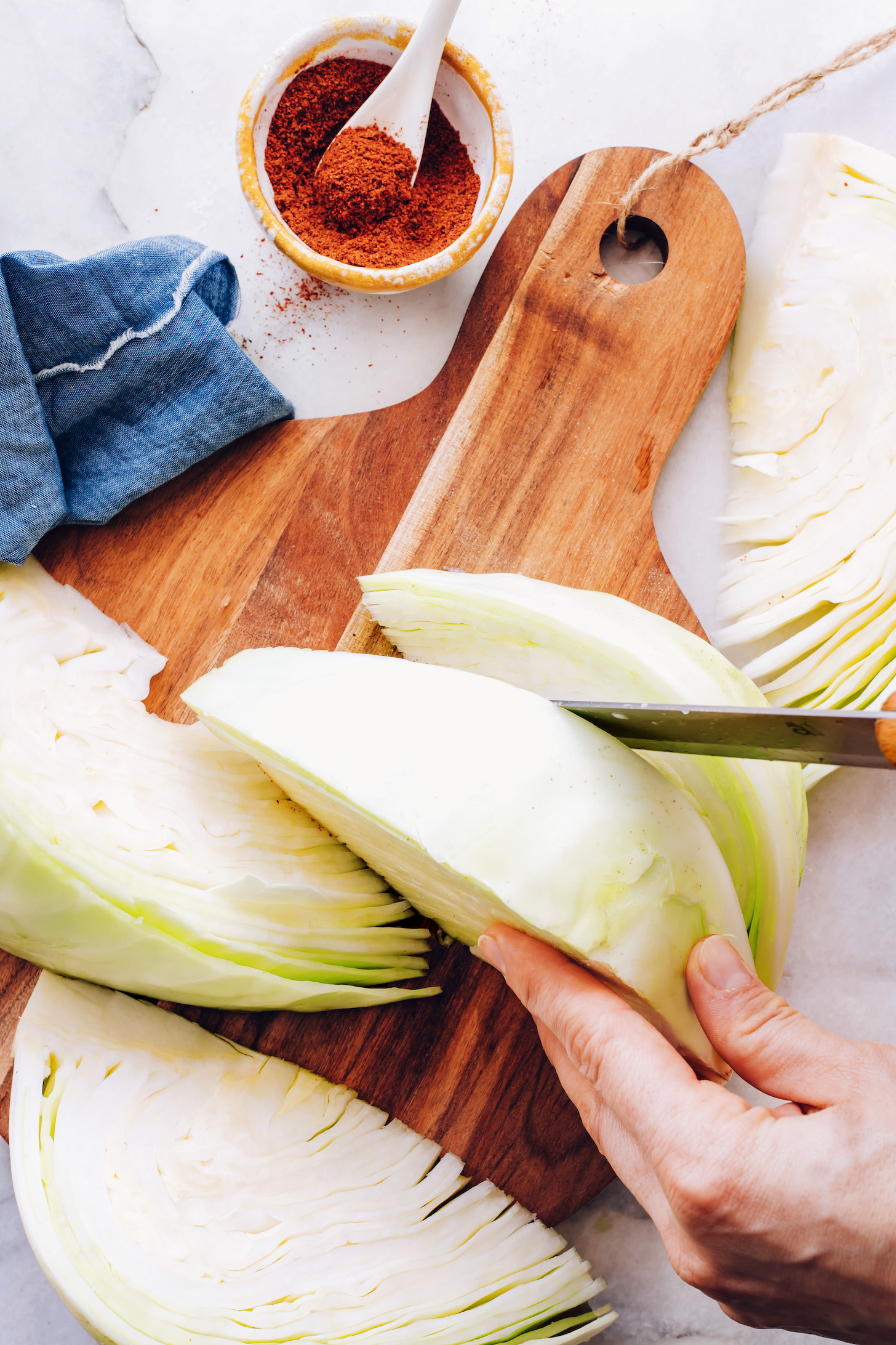 Slicing a green cabbage into wedges