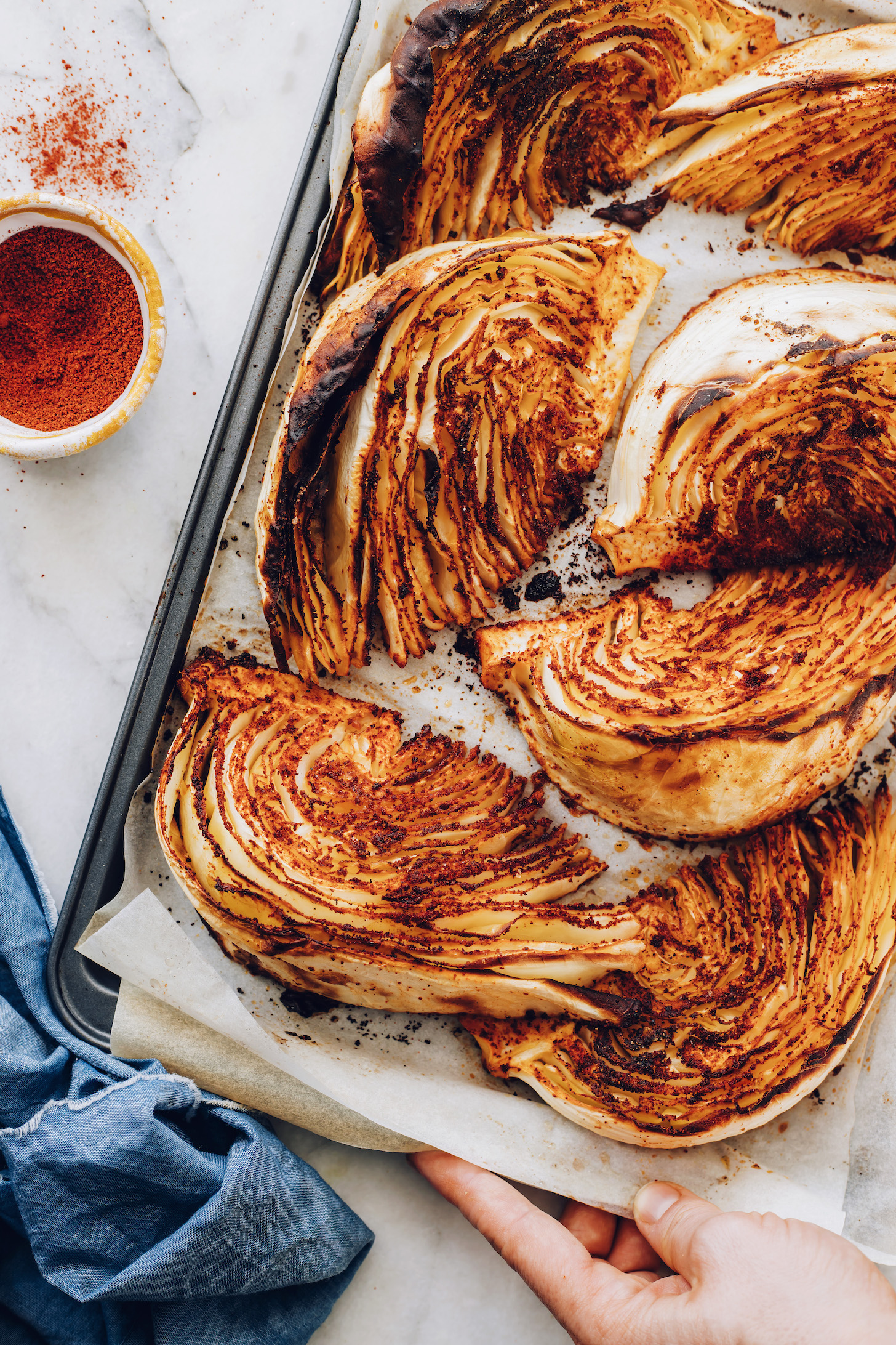 Parchment-lined baking sheet of roasted cabbage wedges