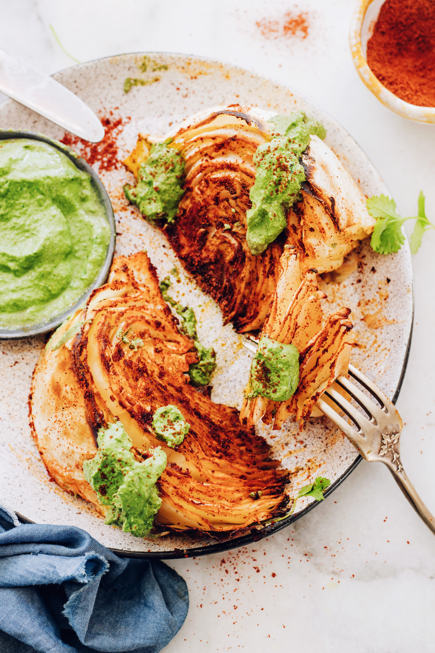 Fork with a bite of a shawarma roasted cabbage wedge on the end