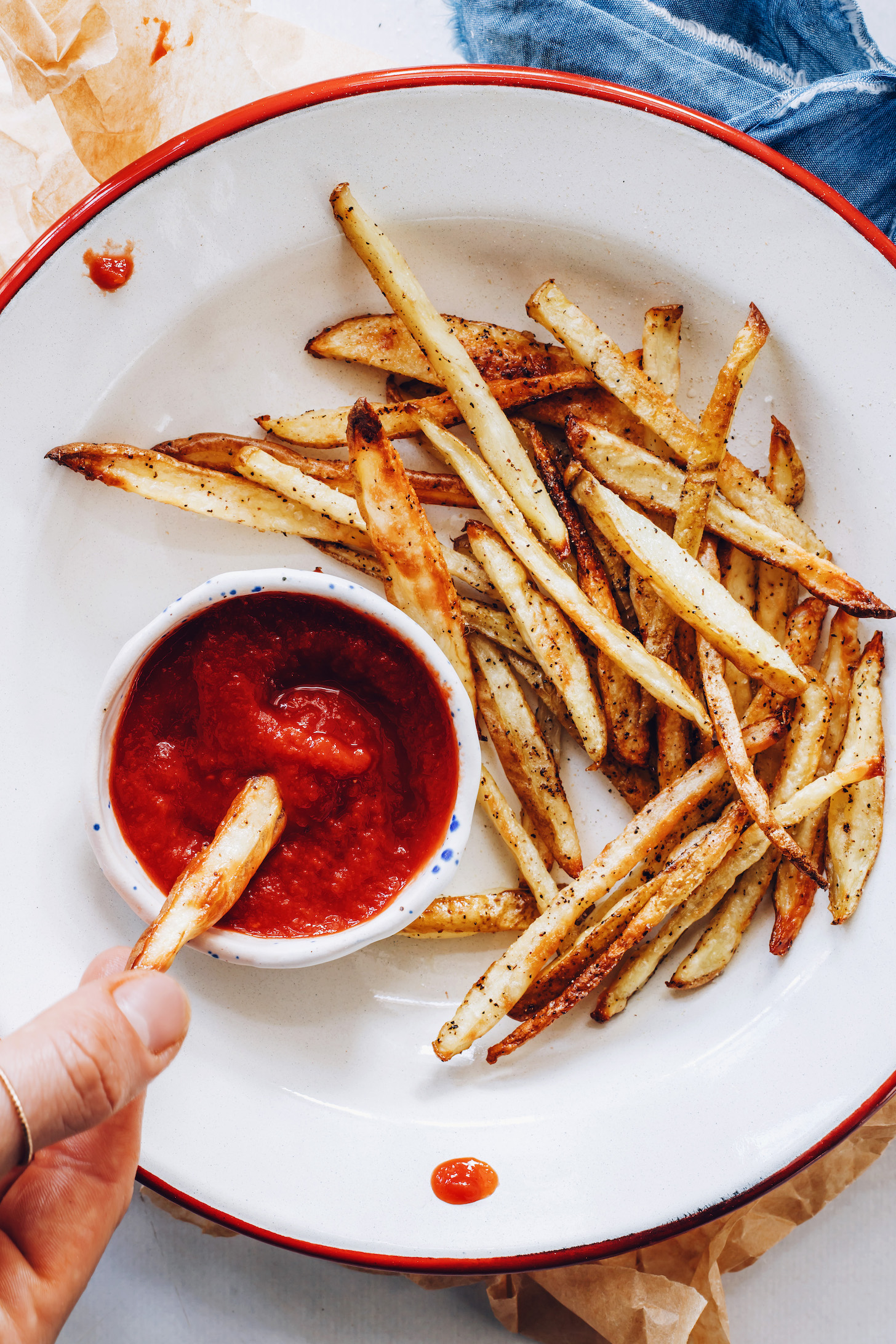 Bowl of homemade ketchup next to a bowl of French fries