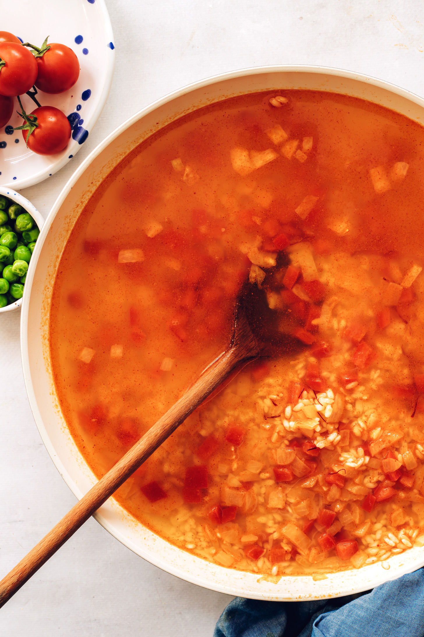 Vegetable broth poured over arborio rice and seasonings