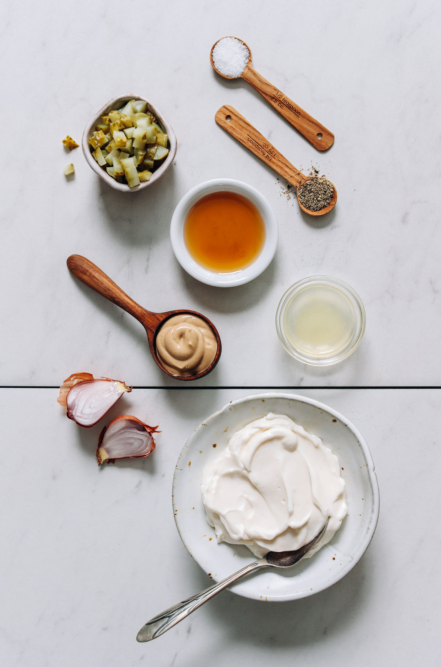 Dill pickles, salt, pepper, maple syrup, lemon juice, mustard, shallot, and vegan mayo
