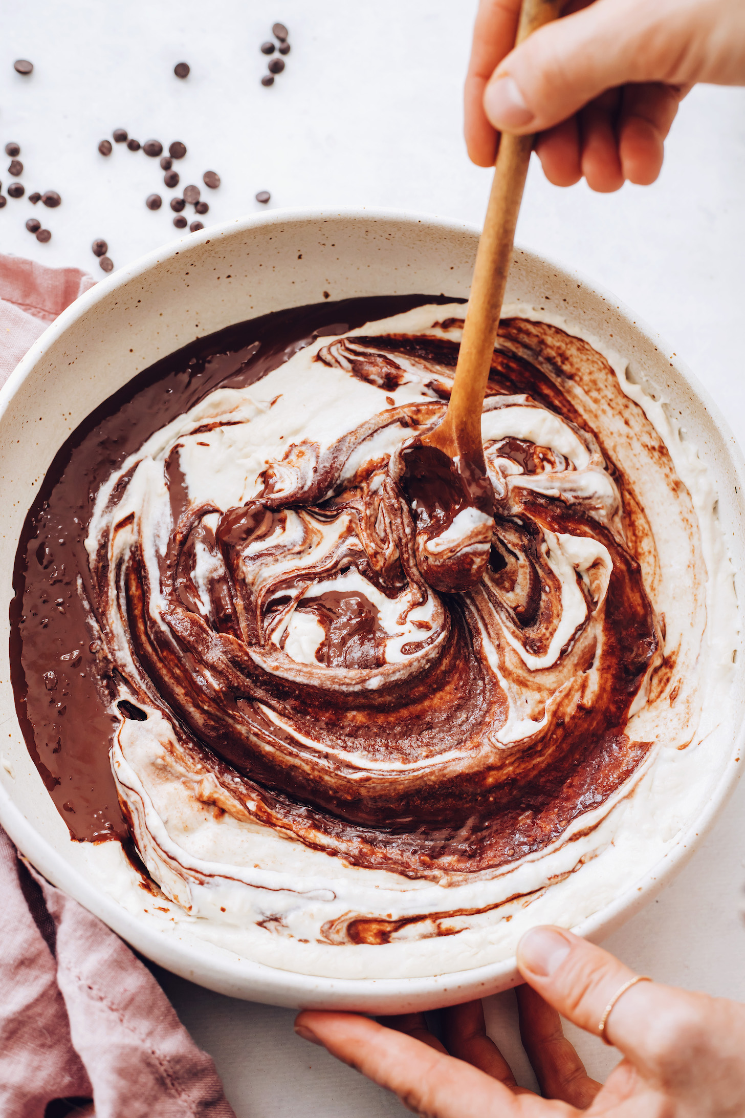 Stirring the cashew cream and melted chocolate to make vegan chocolate ganache