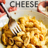 Fork dipping into a bowl of vegan & gluten-free mac and cheese