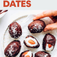 Picking up an almond joy stuffed date from a plate