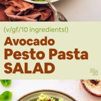 Hands holding a bowl of avocado pesto pasta salad with lemon slices, sun dried tomatoes, and fresh basil