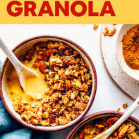 Bowl of Vegan Golden Milk Granola with almond milk and spices