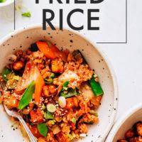 Bowls of Kimchi Fried Rice with snap peas and carrots