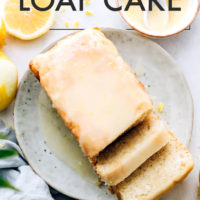 Slices of vegan and gluten-free lemon loaf cake on a plate with lemon icing
