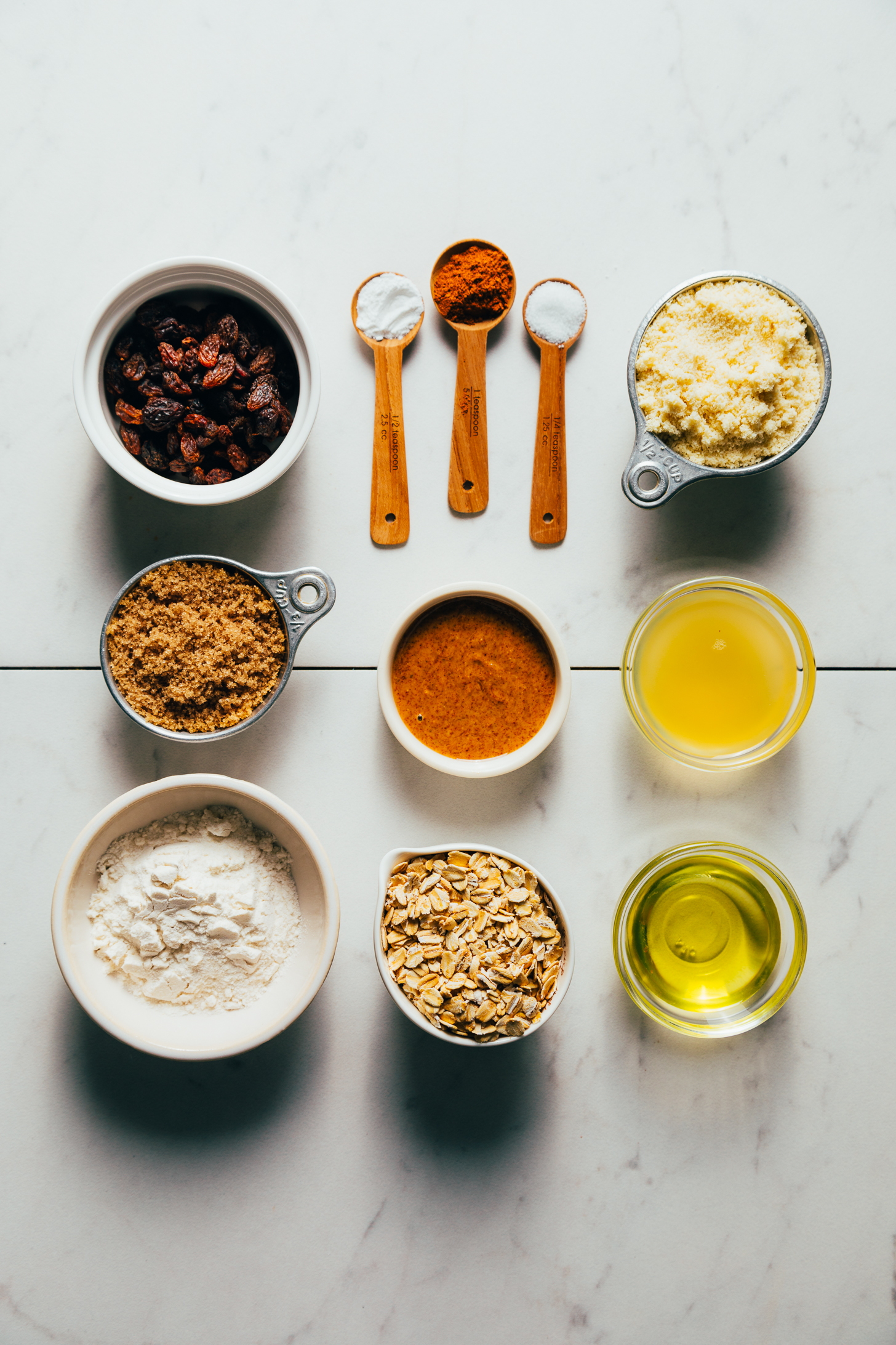 Raisins, brown sugar, gluten-free flour blend, oats, almond butter, baking powder, cinnamon, sea salt, almond flour, chickpea brine, and avocado oil