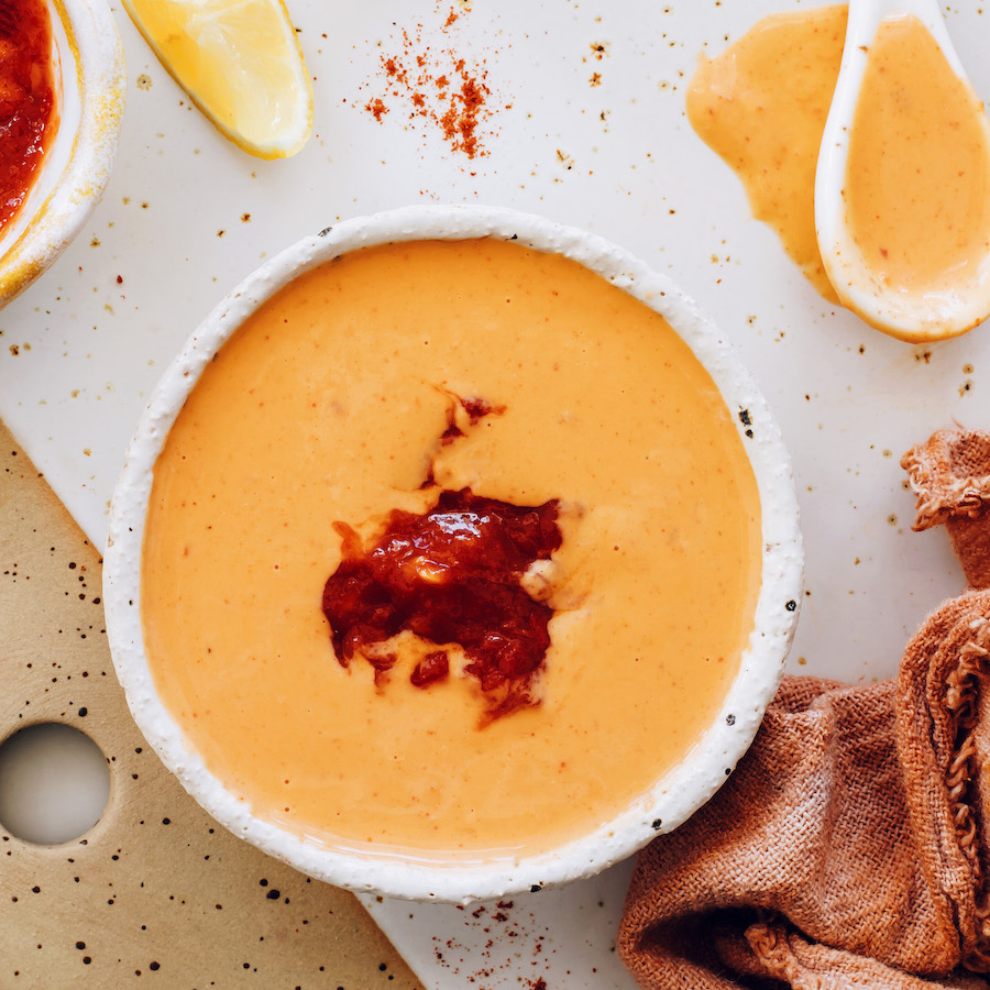 Top down shot of a bowl of creamy harissa sauce