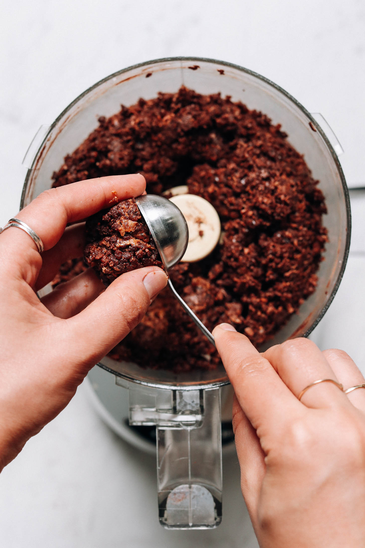 Using a tablespoon to measure no-bake energy bite dough
