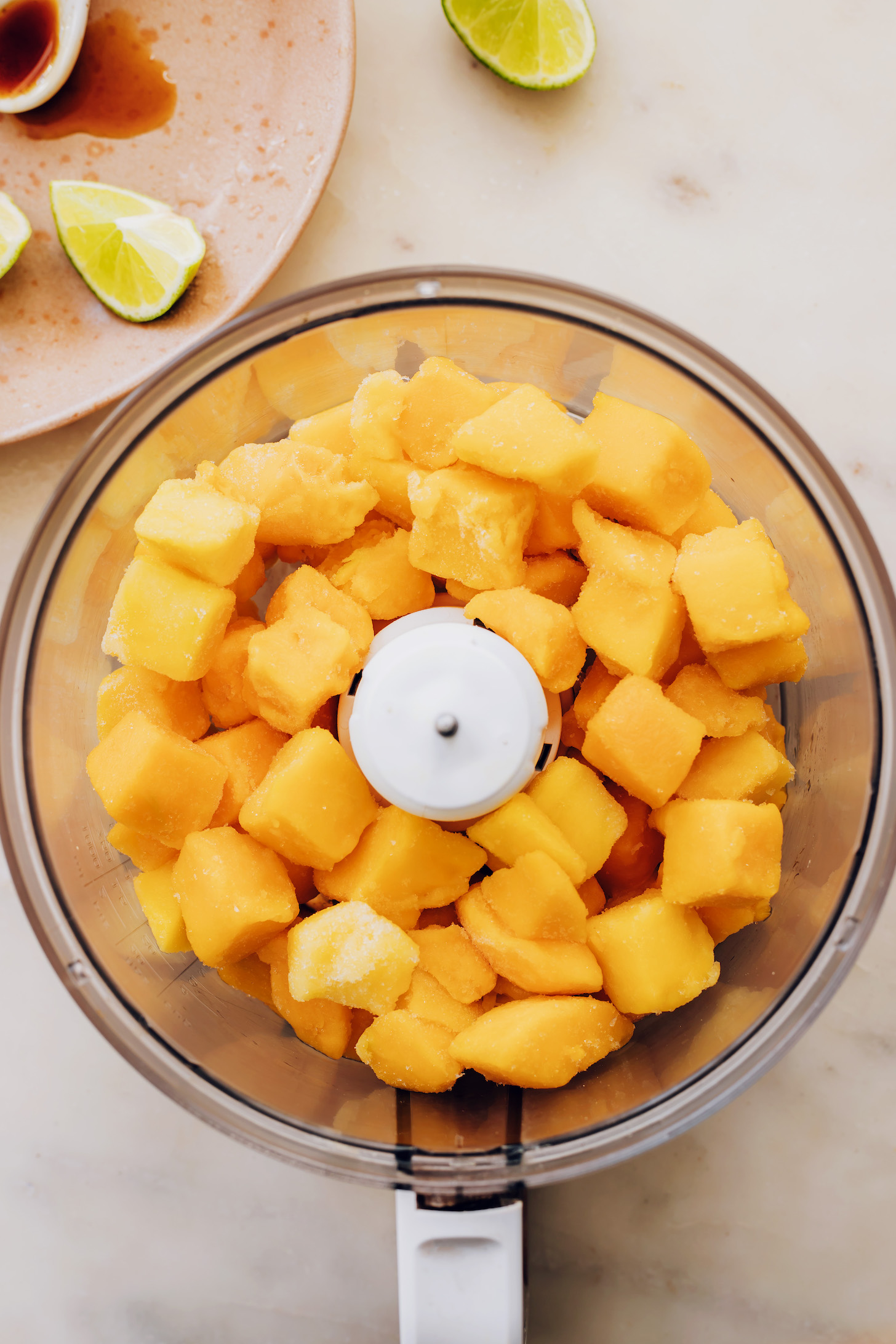 Frozen mango chunks in a food processor