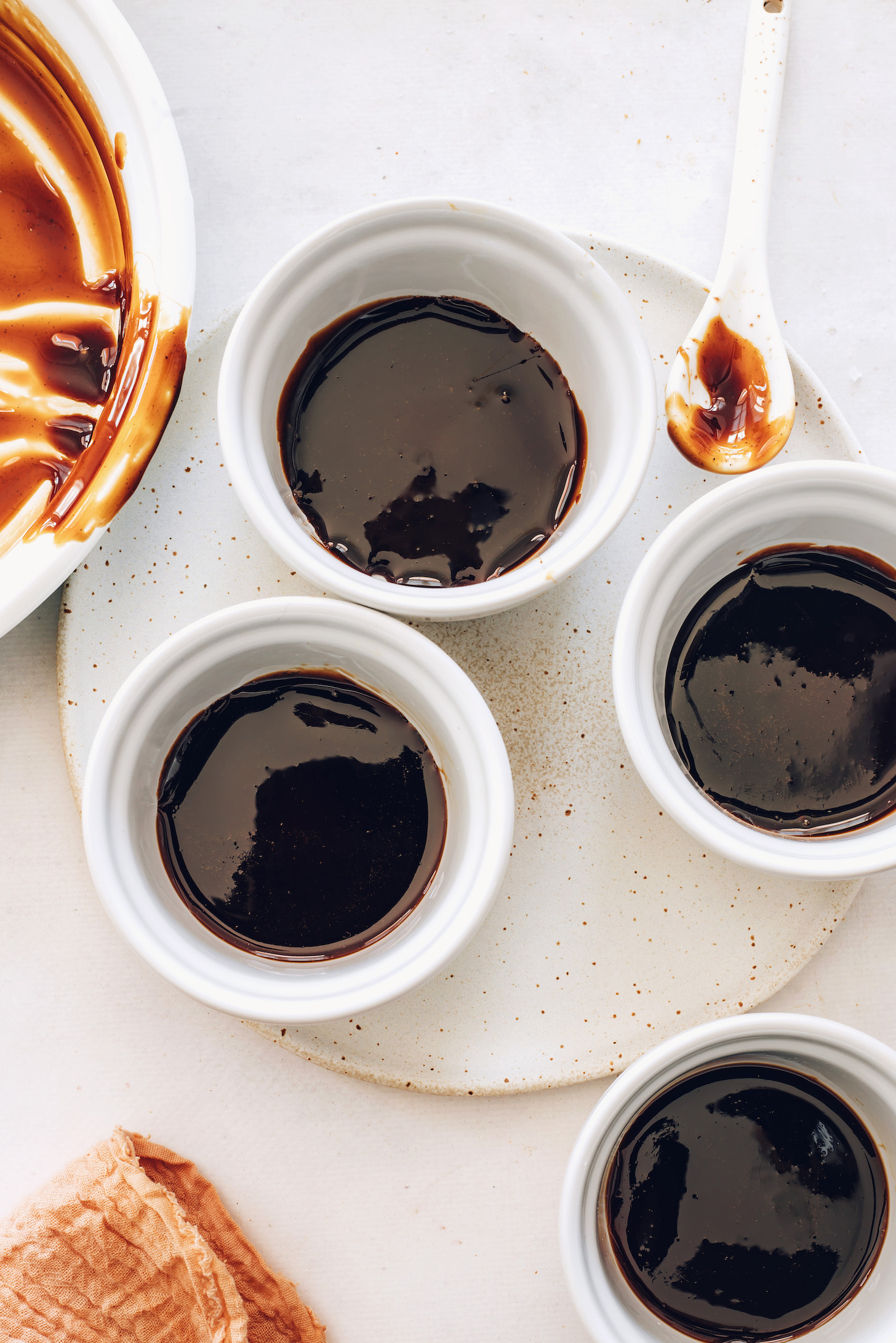 Ramekins with a layer of salted caramel sauce