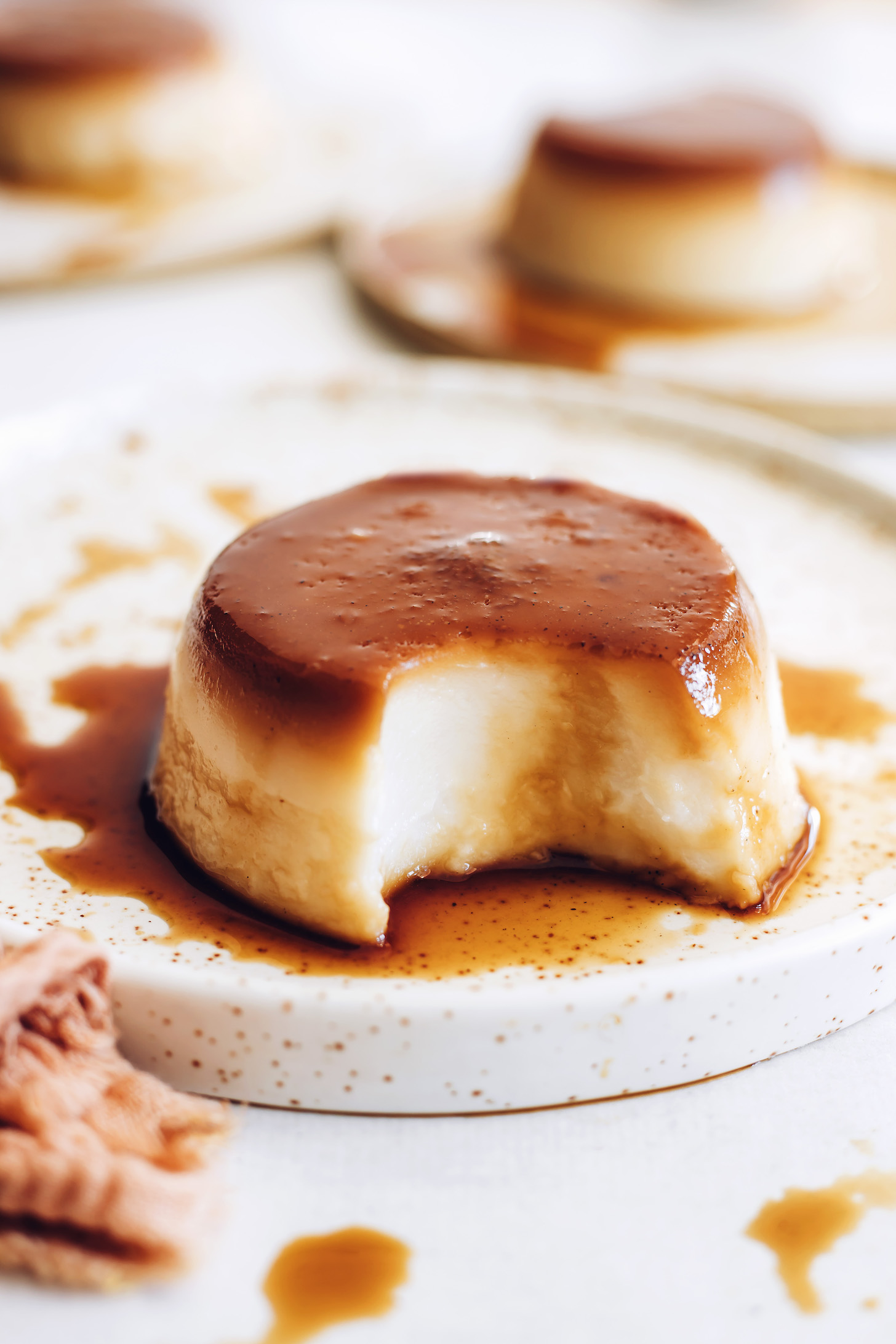 Plate with a portion of vegan flan with a bite removed